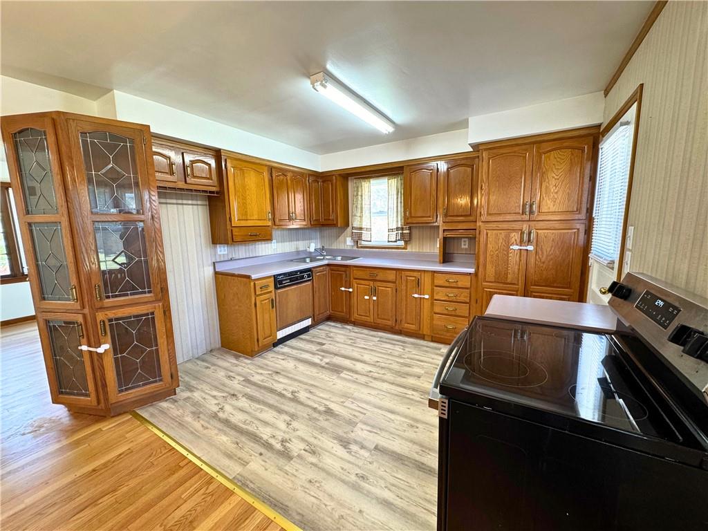 511 Ridgeway Avenue Grove City, PA 16127 - Photo 12 of 18 a kitchen with stainless steel appliances granite countertop a sink stove and refrigerator