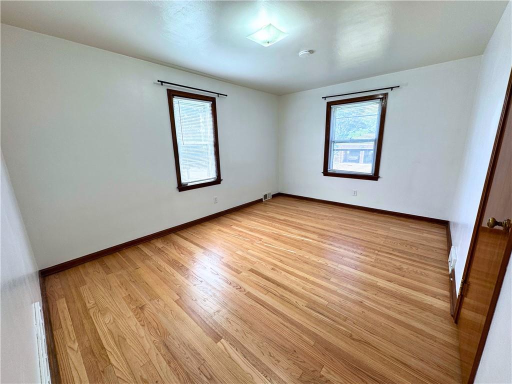 511 Ridgeway Avenue Grove City, PA 16127 - Photo 15 of 18 a view of an empty room with wooden floor and a window