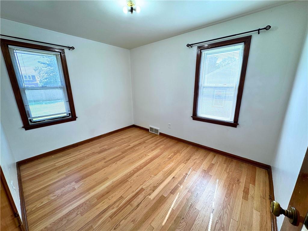 511 Ridgeway Avenue Grove City, PA 16127 - Photo 17 of 18 an empty room with wooden floor and windows