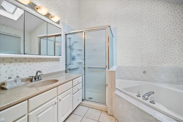 a bathroom with a tub sink and mirror