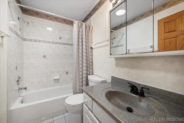 a bathroom with a sink toilet a mirror and shower