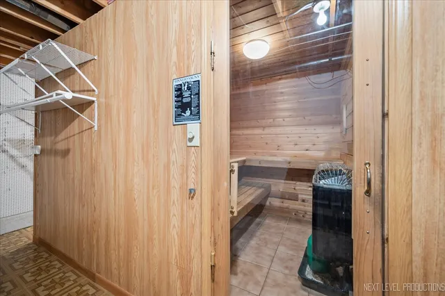 a view of a house with pool plants and wooden fence