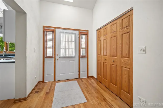 a view of a livingroom with wooden floor and a bathroom