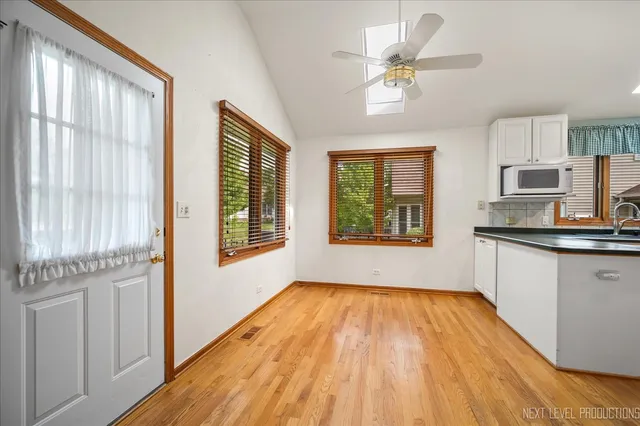 a open kitchen with cabinets a sink and appliances