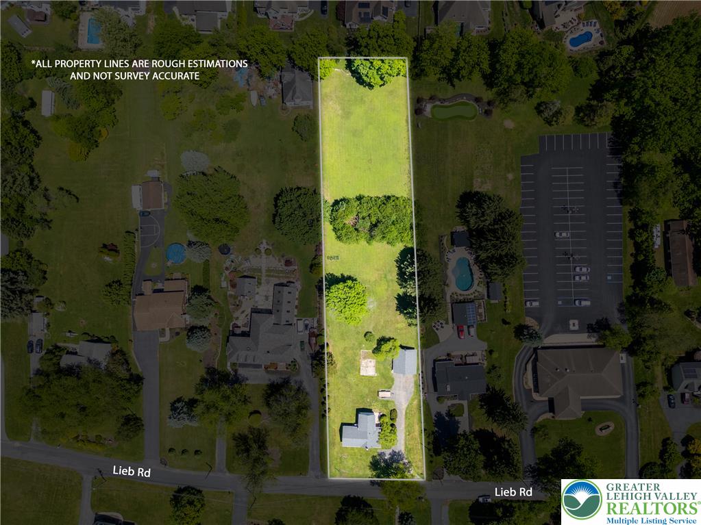 1411 Lieb Road Easton, PA 18040 - Photo 46 of 46 An aerial perspective showcases a spacious lot with mature trees and a residential structure, offering ample green space.