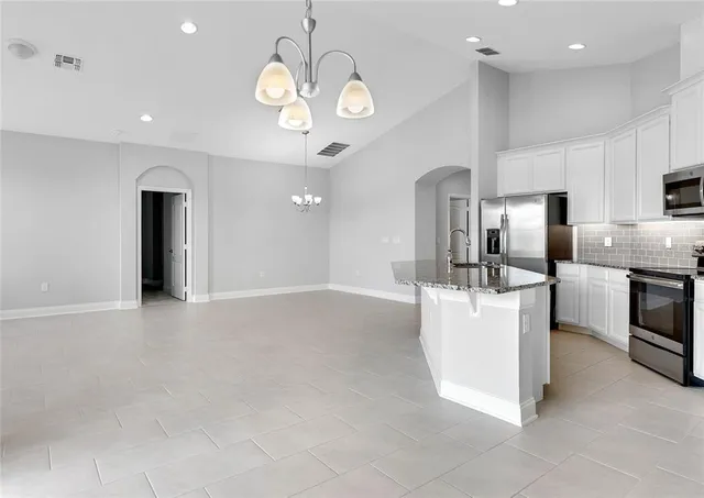 a view of a kitchen with a refrigerator and a sink