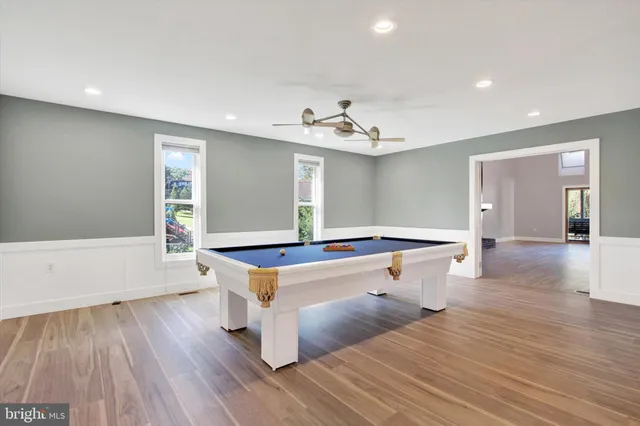 a kitchen with stainless steel appliances granite countertop a refrigerator a stove a sink dishwasher and a refrigerator with wooden floor