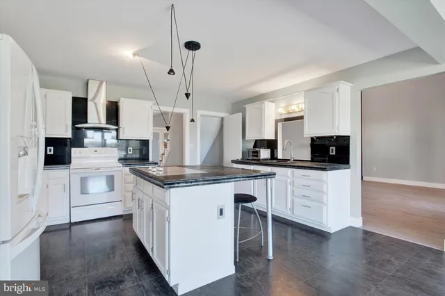 a kitchen with stainless steel appliances granite countertop wooden floors sink and cabinets