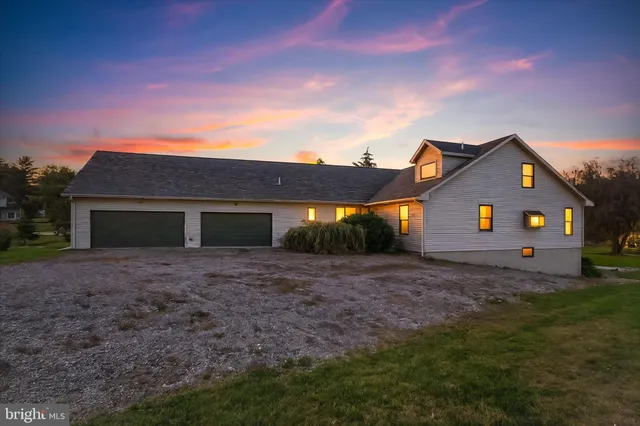 a front view of house with yard and trees