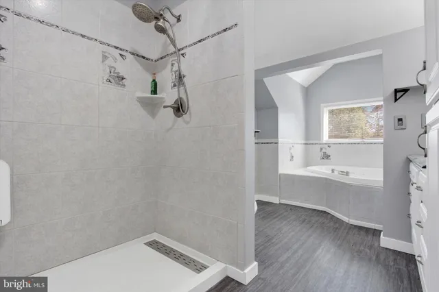 an empty room with a ceiling fan and a window