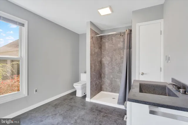 a spacious bedroom with a bed and a chandelier