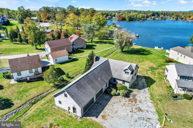 an aerial view of a house with garden space and ocean view