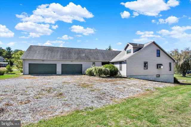 an aerial view of a house with garden space and ocean view