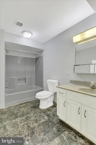 a view of an empty room with a ceiling fan