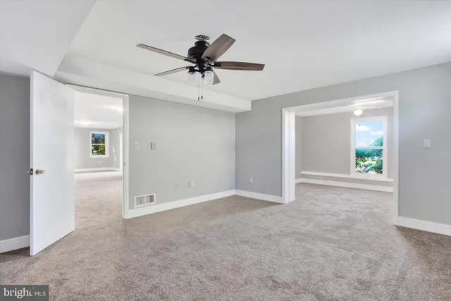 an aerial view of a house with garden space and swimming pool