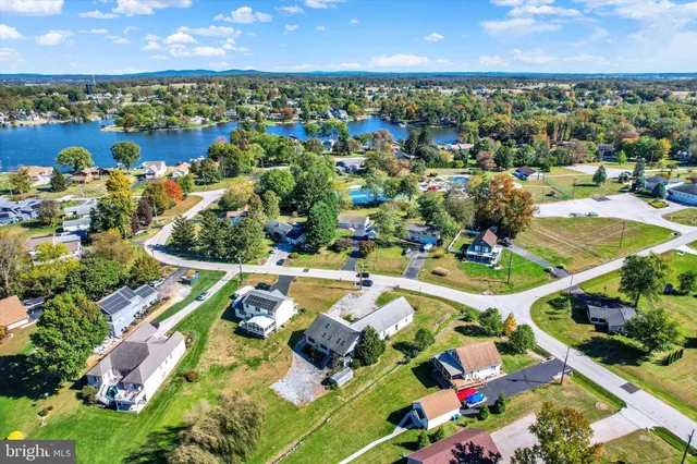 an aerial view of residential houses with outdoor space and swimming pool