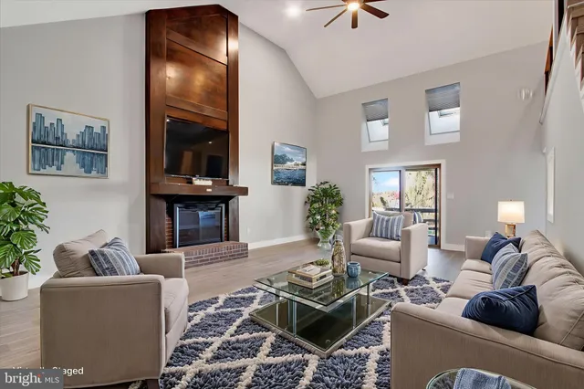 a view of a livingroom with wooden floor and stairs