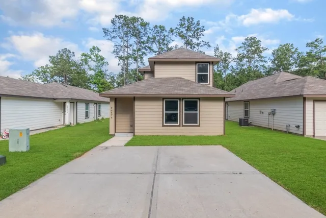 a front view of a house with a yard and garage