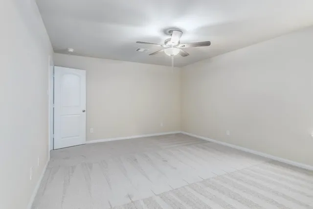 a bathroom with a granite countertop sink toilet and mirror