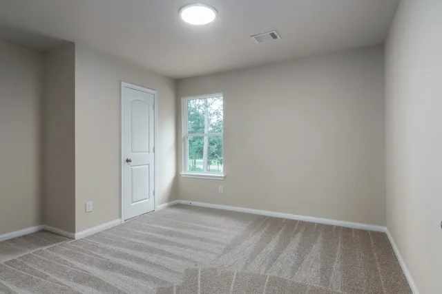 a view of an empty room and wooden floor