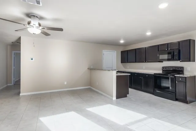 a kitchen with kitchen island microwave and stove