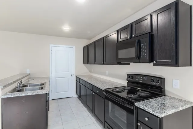 a kitchen with a sink and cabinets