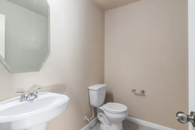 a view of an empty room with a chandelier fan