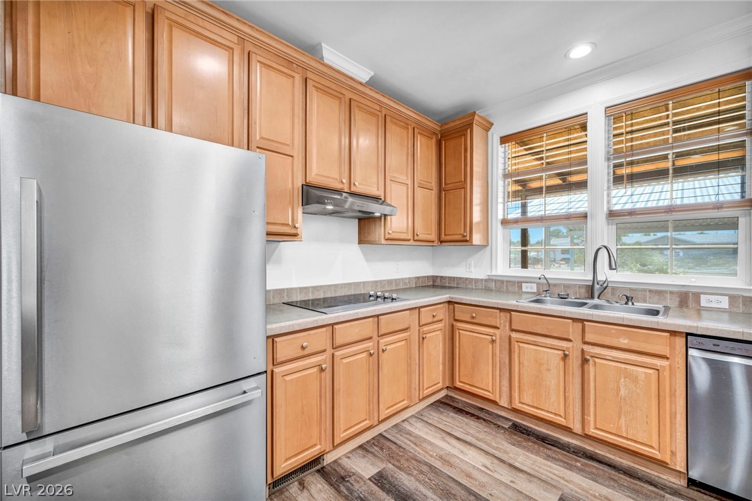 225 California Street Searchlight, NV 89046 - Photo 25 of 64 A well-appointed kitchen features ample cabinetry, modern appliances, and a double-basin sink beneath sun-filled windows.