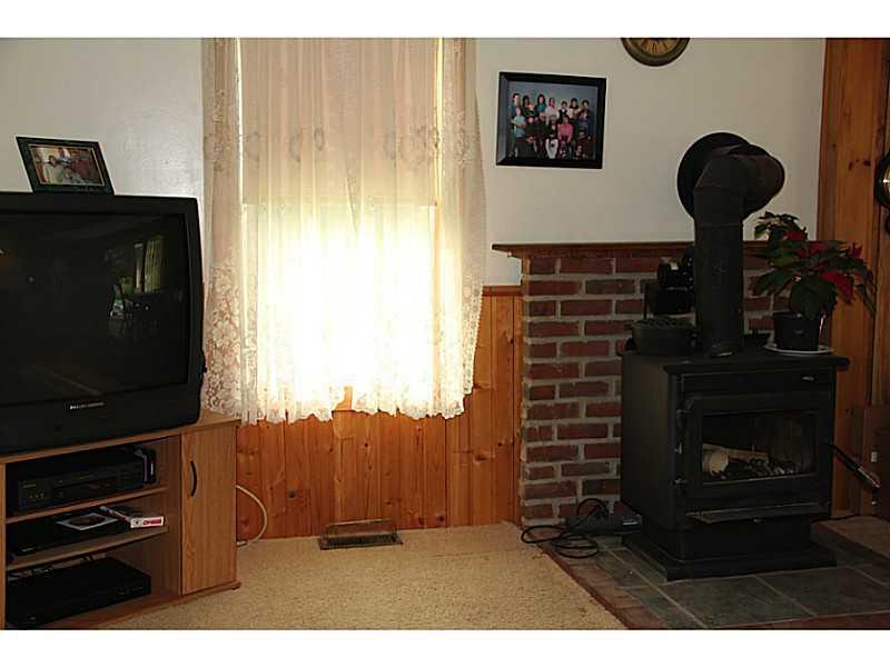 646 Newell Brook Road Durham, ME 04222 - Photo 4 of 34 Living Room. Wood stove on brick hearth