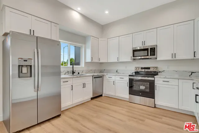 a bedroom with a bed and flat screen tv