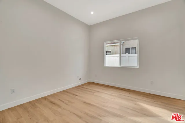 a spacious bedroom with a bed and a couch