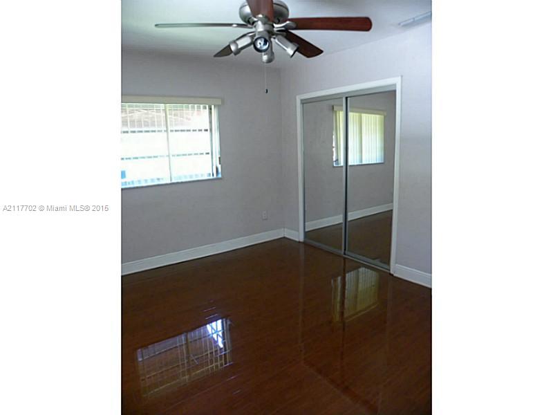 6180 Southwest 11th Street West Miami, FL 33144 - Photo 14 of 20 a view of a livingroom with a ceiling fan and window