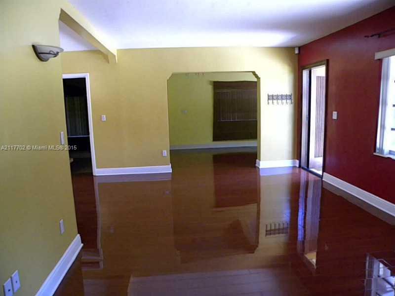 6180 Southwest 11th Street West Miami, FL 33144 - Photo 8 of 20 a view of hallway with stairs and wooden floor