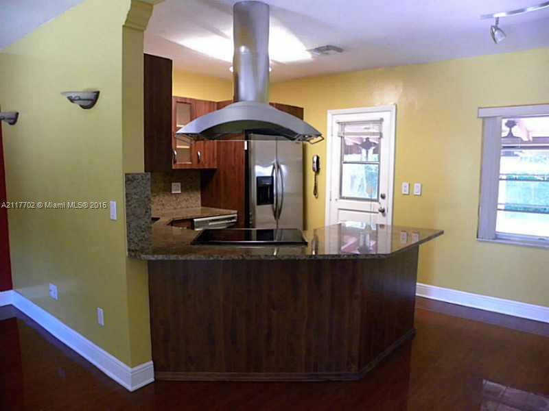 6180 Southwest 11th Street West Miami, FL 33144 - Photo 10 of 20 a kitchen with stainless steel appliances granite countertop a sink a stove wooden floor and a window