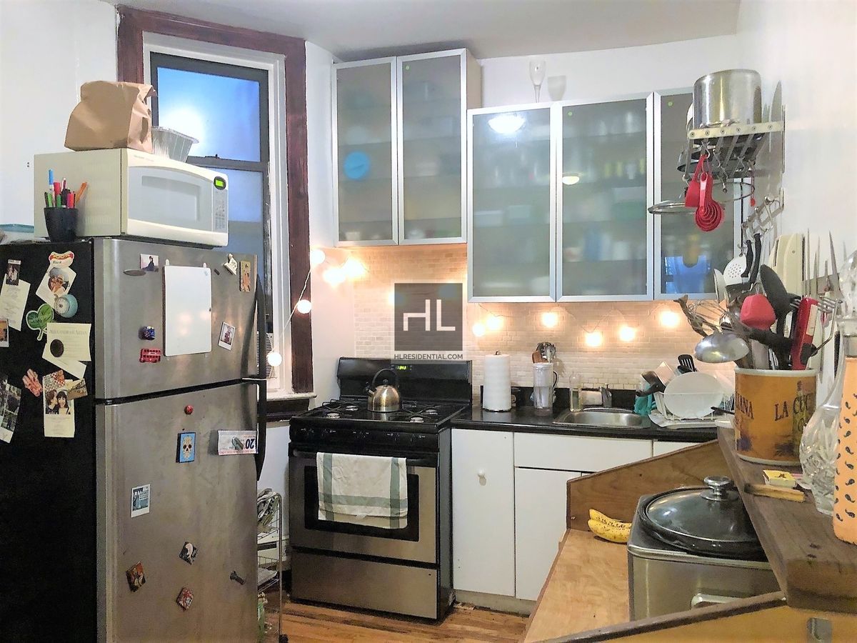 a kitchen with refrigerator and stove