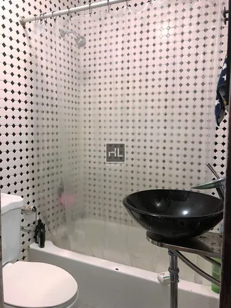 a bathroom with a shower and a toilet