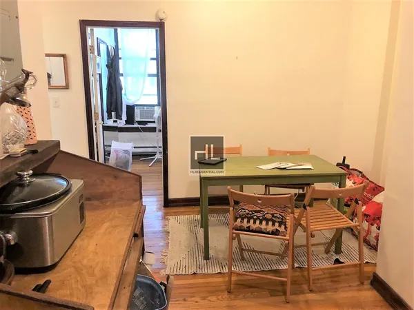 a living room with a table and chairs