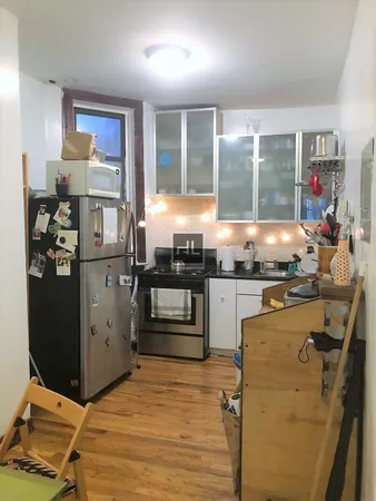 a kitchen with stainless steel appliances granite countertop a refrigerator and a stove