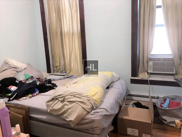 a bedroom with a bed and a window