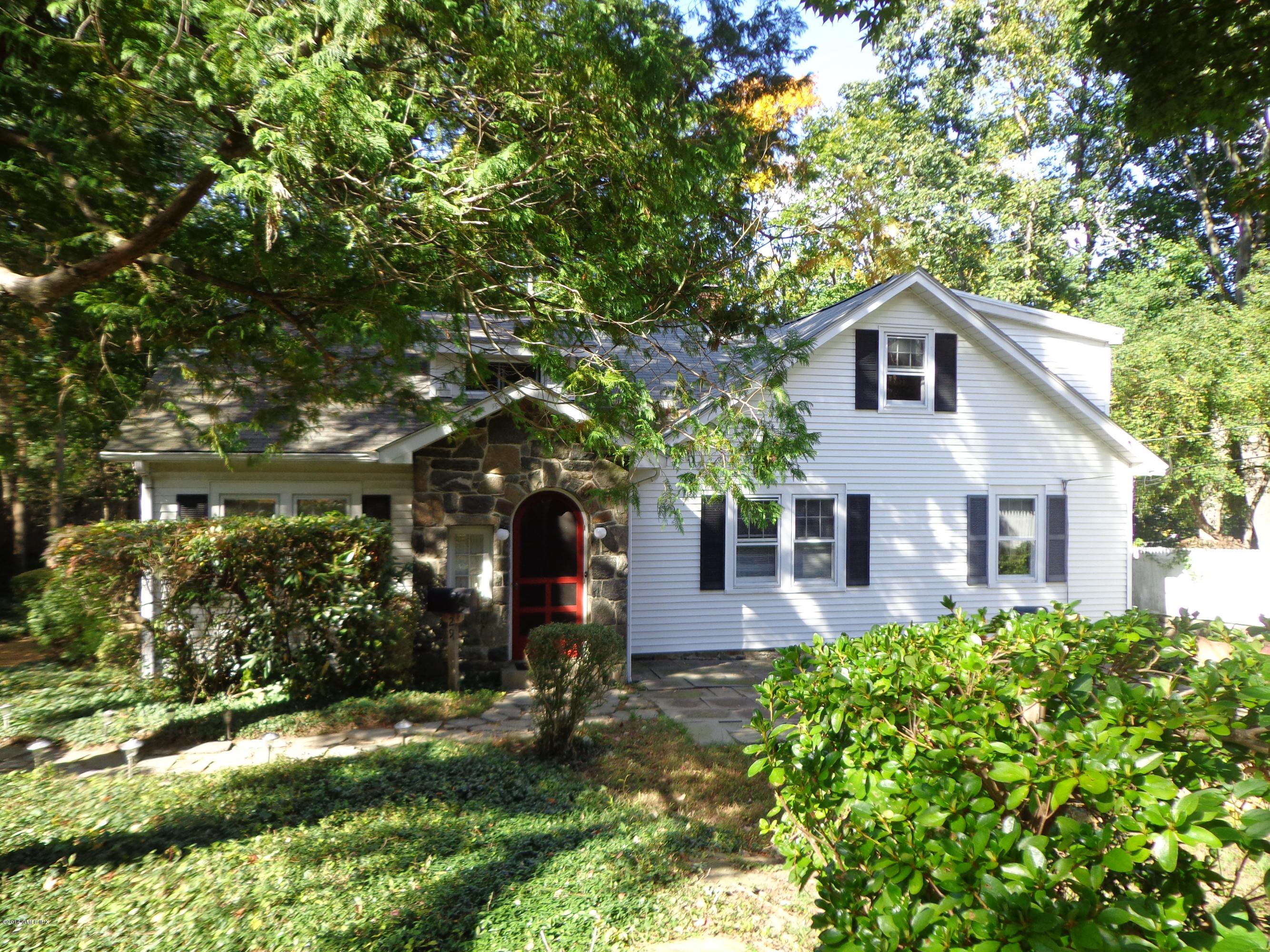 29 Butler Street Cos Cob, CT 06807 - Photo 1 of 24 a front view of a house with a yard