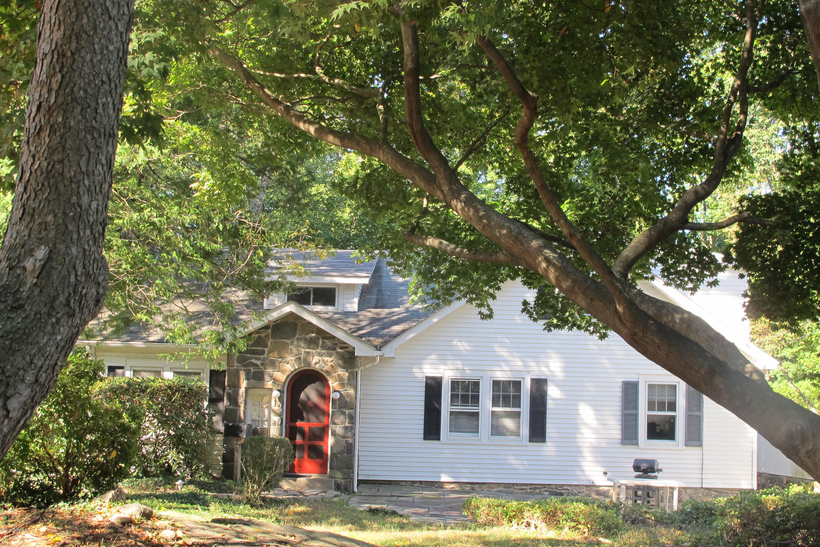 29 Butler Street Cos Cob, CT 06807 - Photo 3 of 24 a front view of a house with a yard