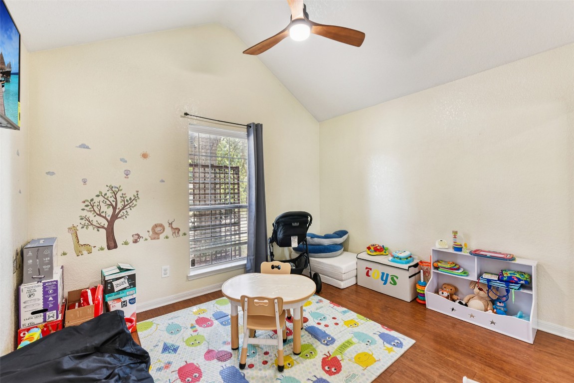 5318 West Ridge Boulevard Temple, TX 76502 - Photo 13 of 27 Playroom with vaulted ceiling, wood finished floors, and a ceiling fan