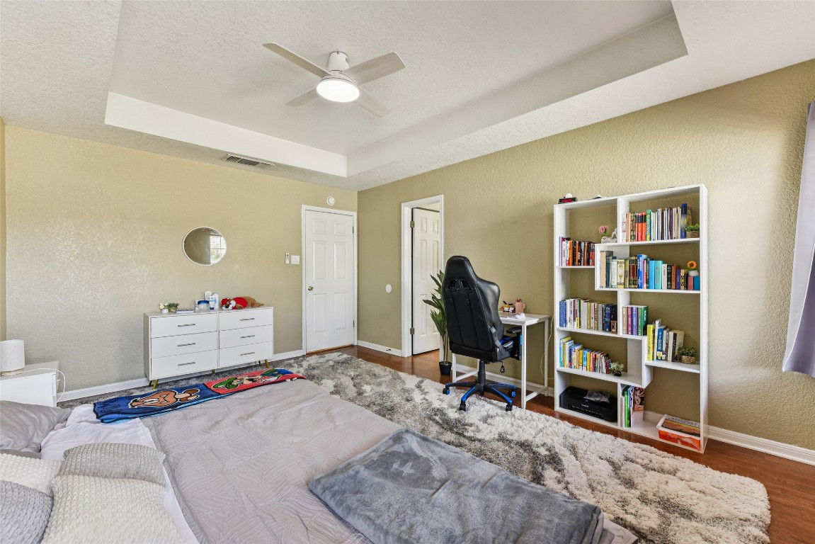 5318 West Ridge Boulevard Temple, TX 76502 - Photo 17 of 27 Office featuring a raised ceiling, a textured wall, wood finished floors, ceiling fan, and a textured ceiling