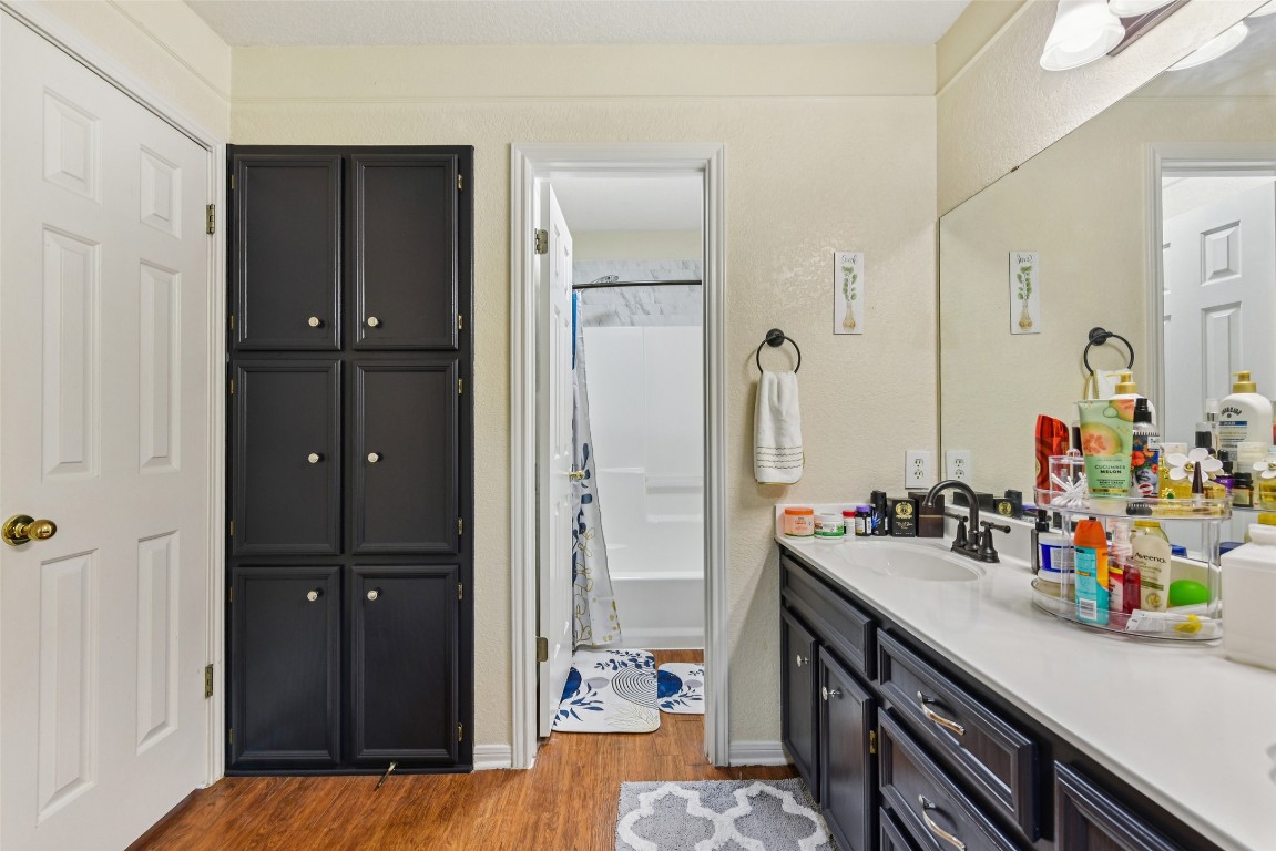5318 West Ridge Boulevard Temple, TX 76502 - Photo 20 of 27 Full bath featuring dark wood-style floors, vanity, a textured wall, and shower / bath combo