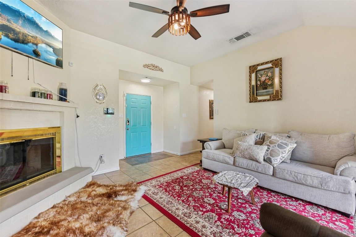 5318 West Ridge Boulevard Temple, TX 76502 - Photo 4 of 27 Tiled living area with a glass covered fireplace and ceiling fan
