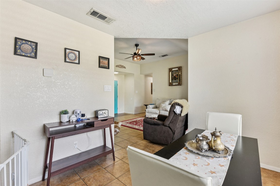 5318 West Ridge Boulevard Temple, TX 76502 - Photo 5 of 27 Living room with light tile patterned flooring, a textured wall, ceiling fan, and a textured ceiling