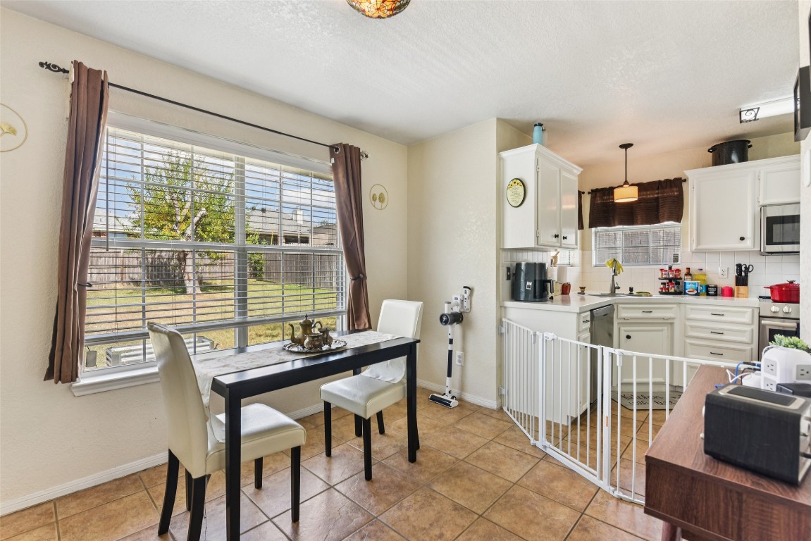 5318 West Ridge Boulevard Temple, TX 76502 - Photo 8 of 27 Dining room featuring light tile patterned flooring and a textured ceiling