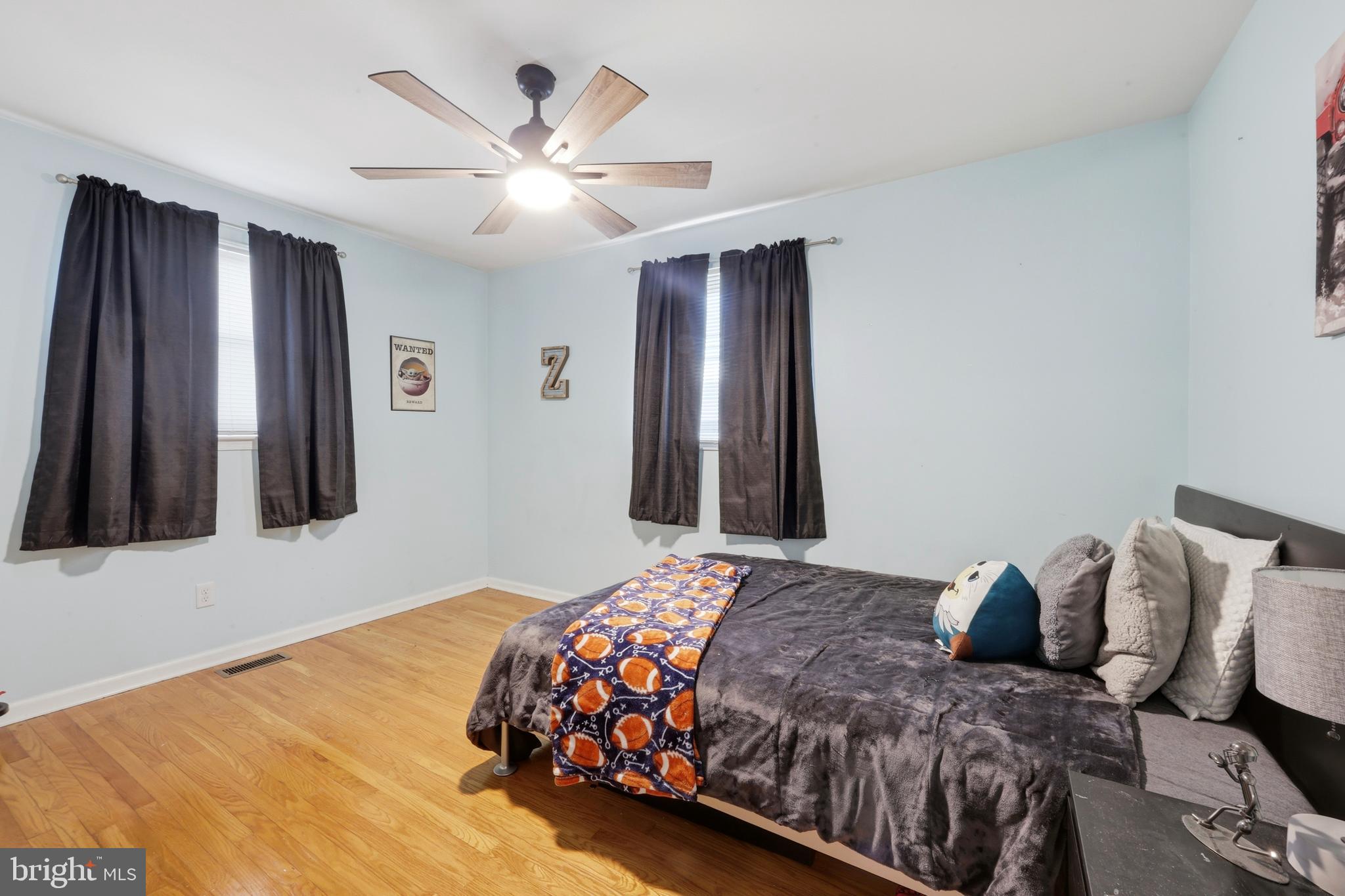 129 Maple Avenue Brookhaven, PA 19015 - Photo 11 of 16 a bedroom with a bed and a chandelier
