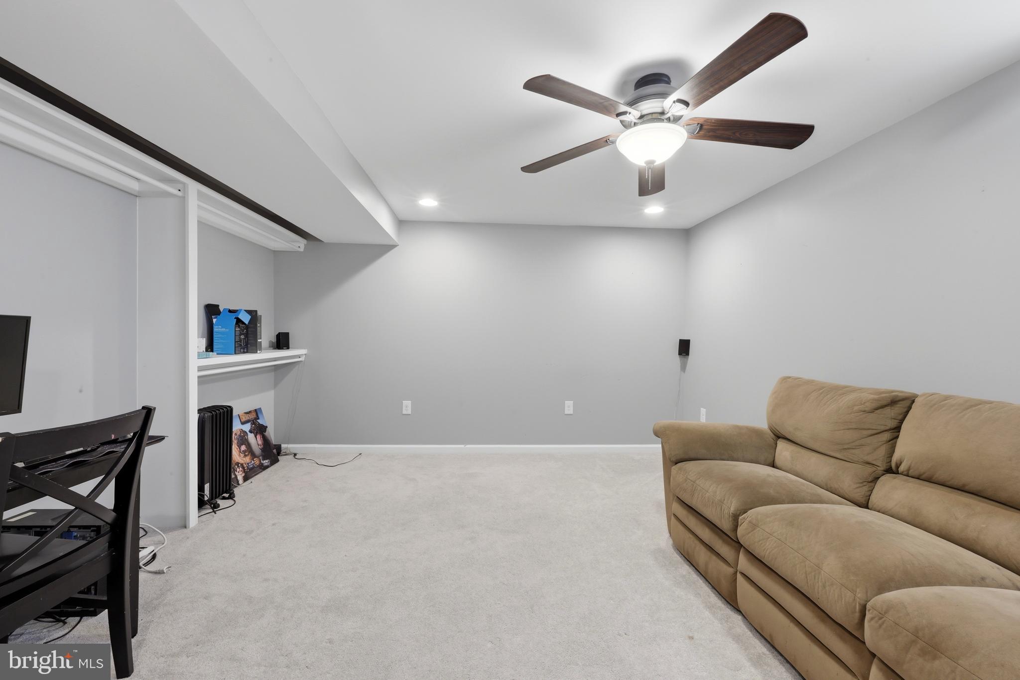 129 Maple Avenue Brookhaven, PA 19015 - Photo 13 of 16 a living room with furniture and a ceiling fan