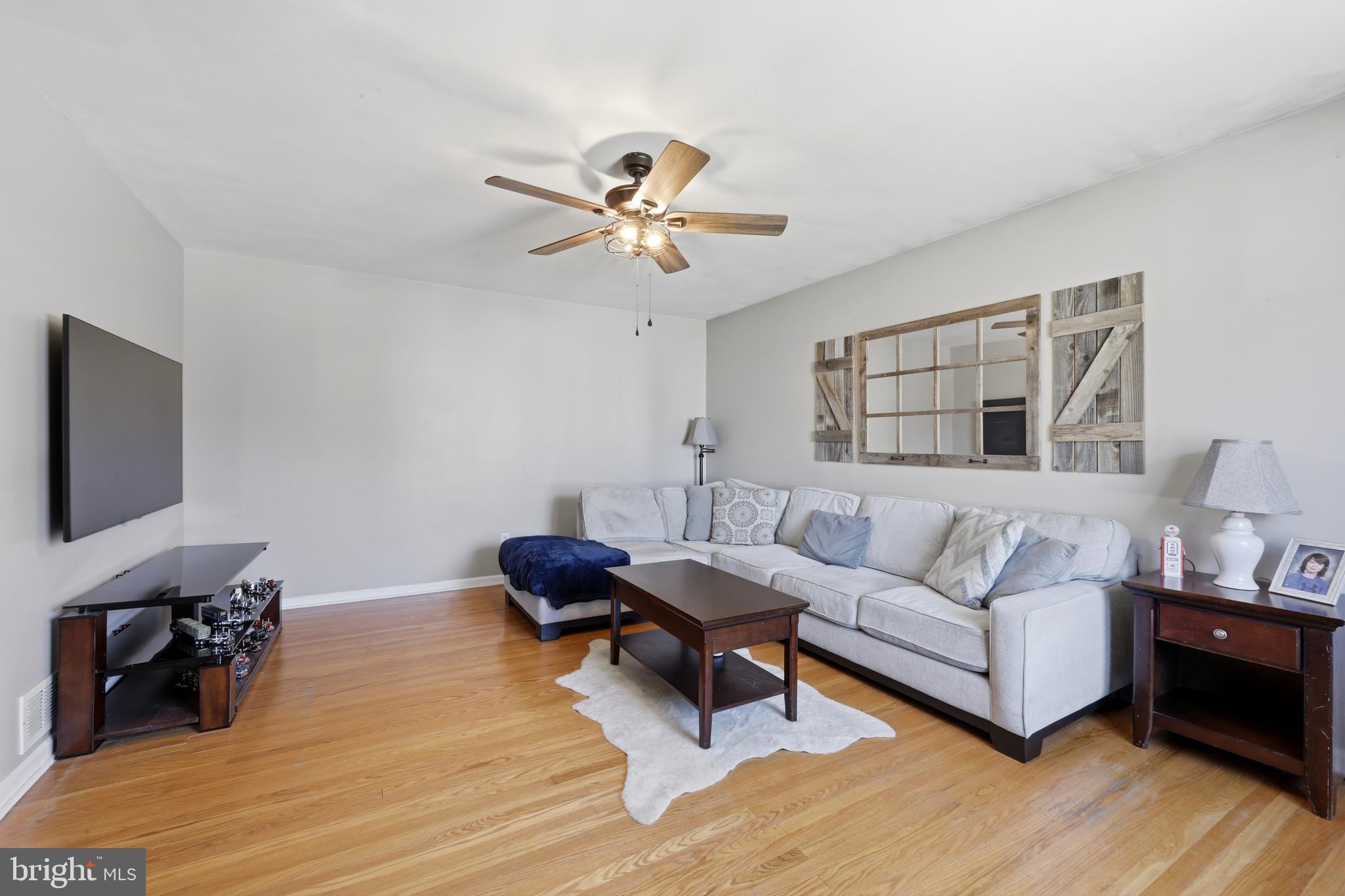129 Maple Avenue Brookhaven, PA 19015 - Photo 5 of 16 a living room with furniture and a flat screen tv